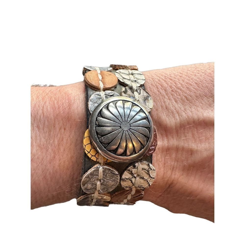 Leather cuff with silver concho snap closure